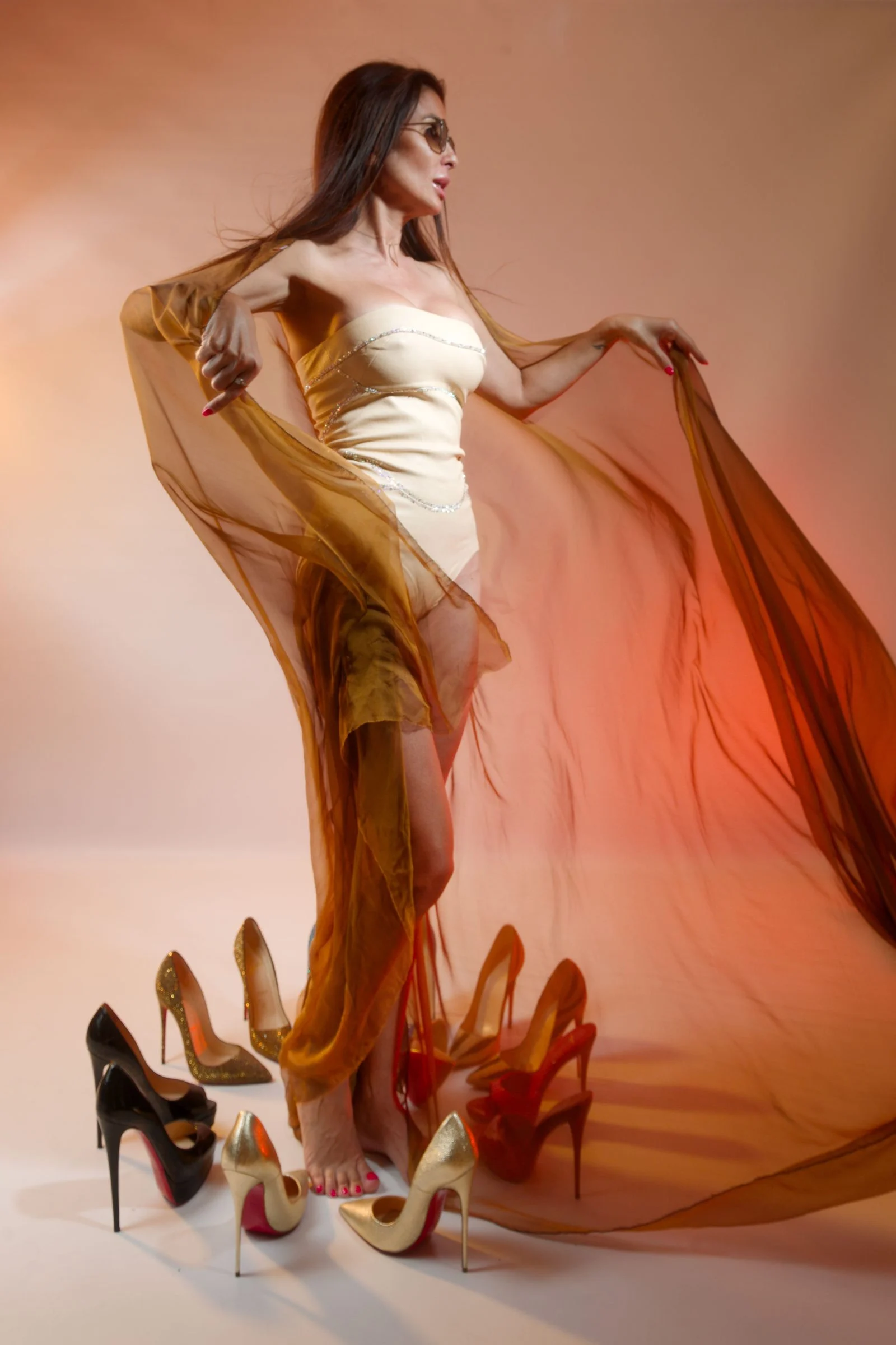 Goddess Oksana standing in an amber silk veil
