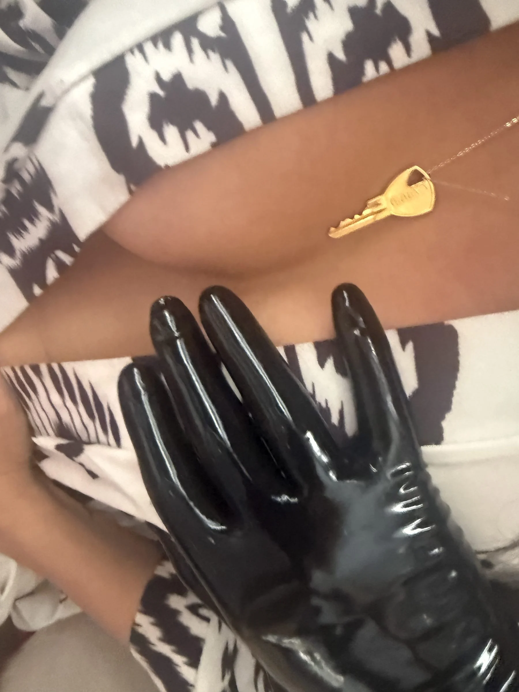 A black-gloved hand, detail